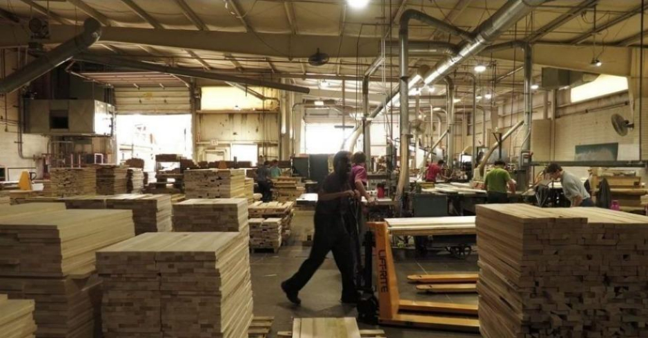 Workers crafting wooden bedroom furniture inside the Vaughan-Bassett factory in Galax, Virginia.
