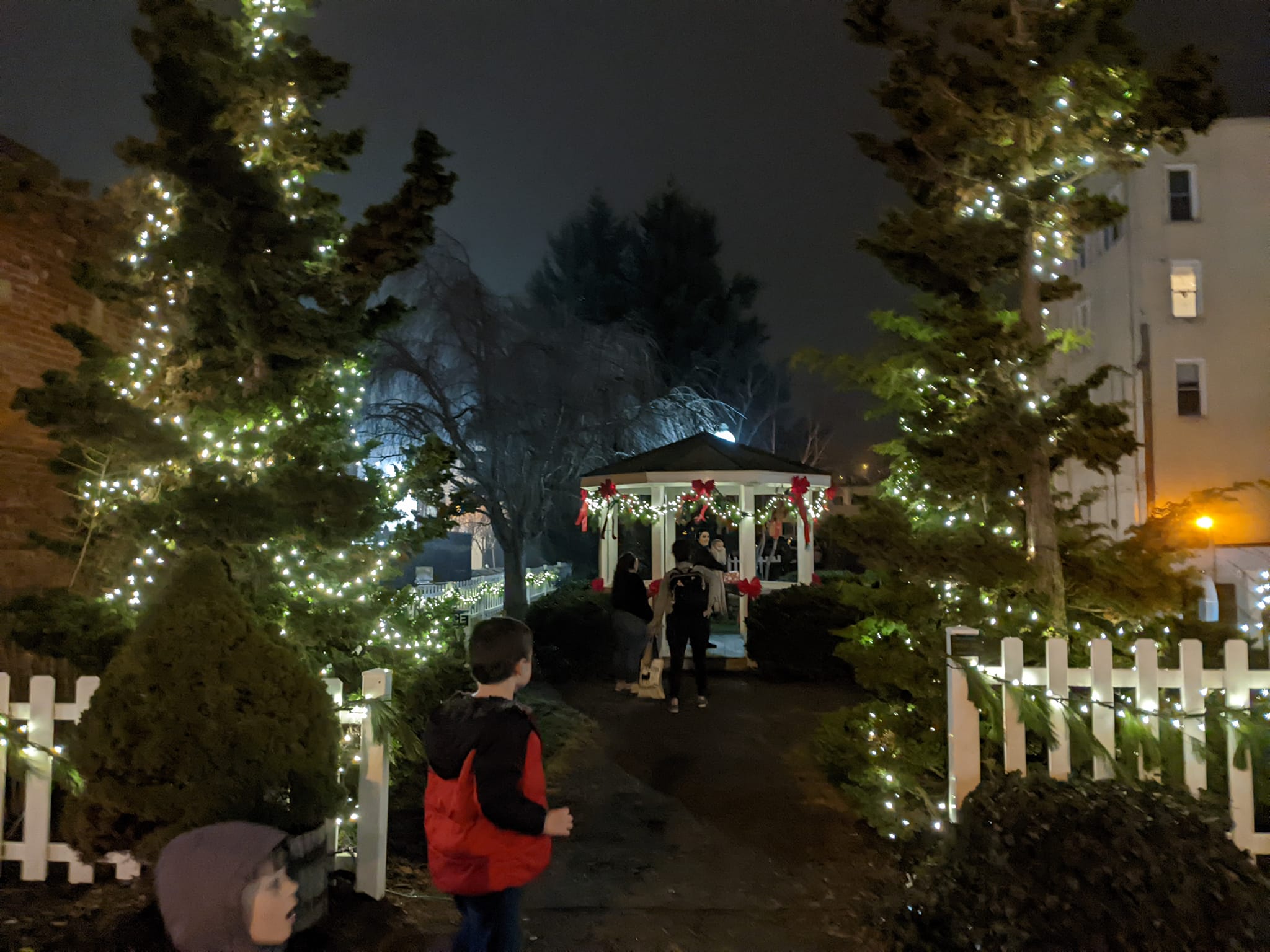 Visitors walking toward the gazebo decorated with lights during the 2024 Old Time Appalachian Christmas Festival in Galax.