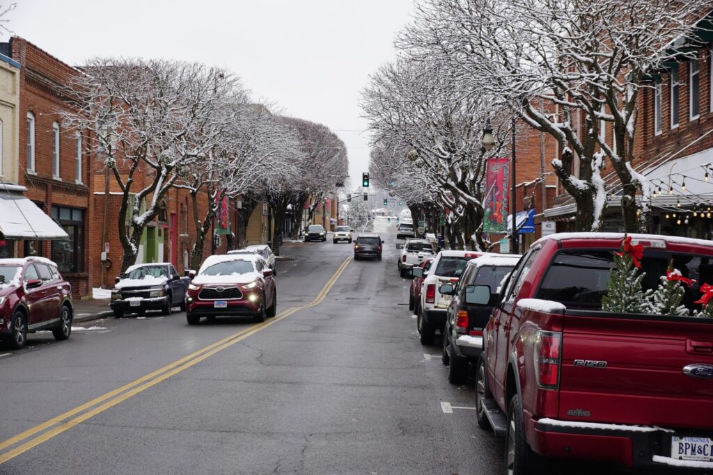 Snow-dusted trees and parked cars along Main Street in downtown Galax.