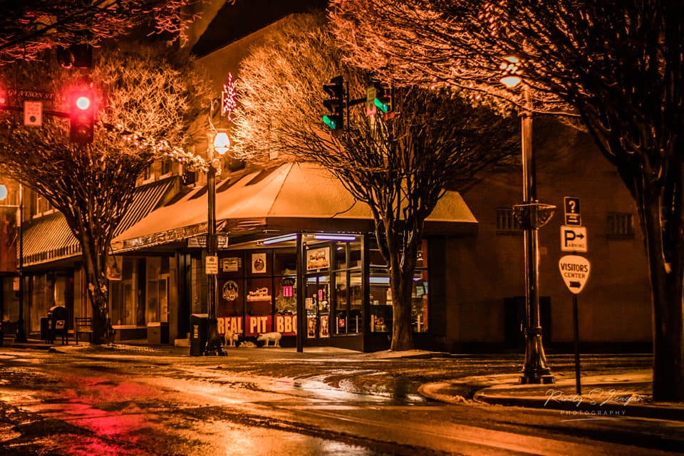 Galax Smokehouse lit up at night in downtown Galax