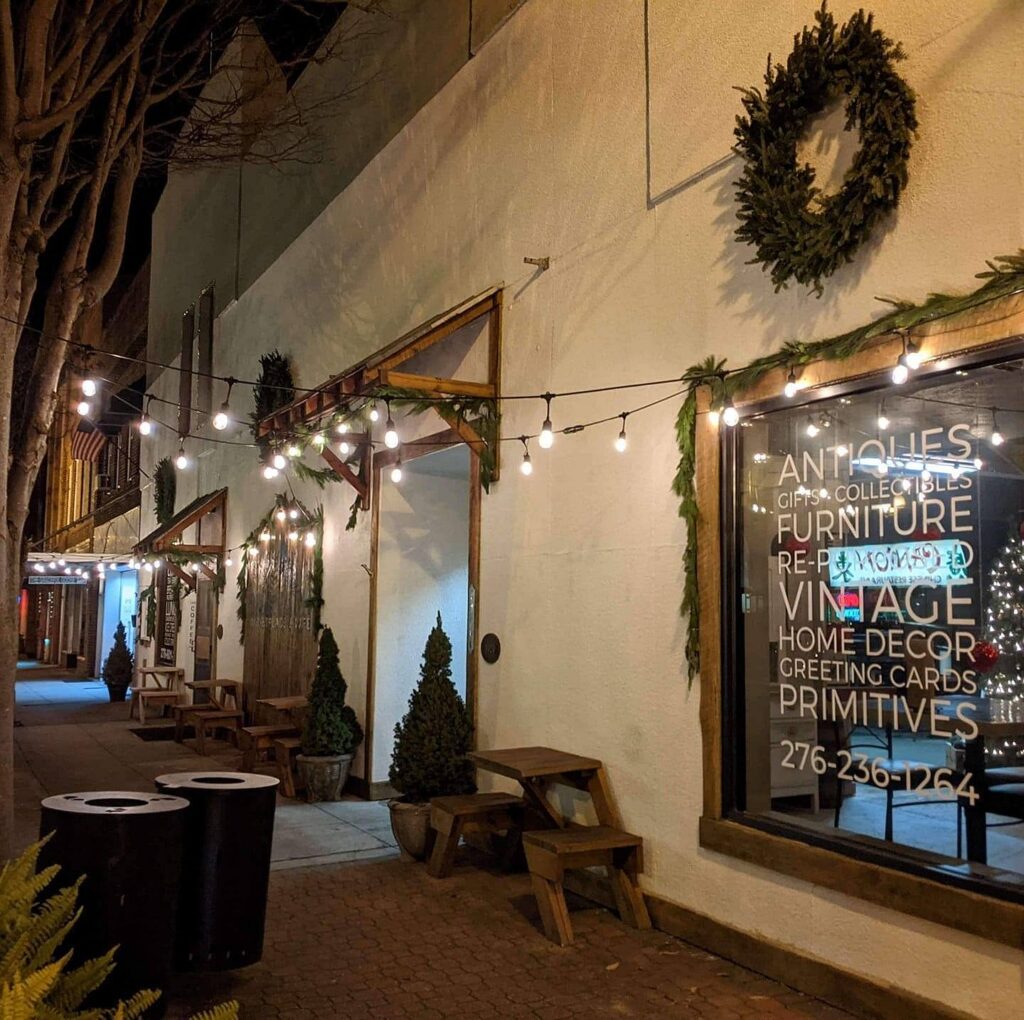 Evening view of Galax antique stores with storefront windows and string lights