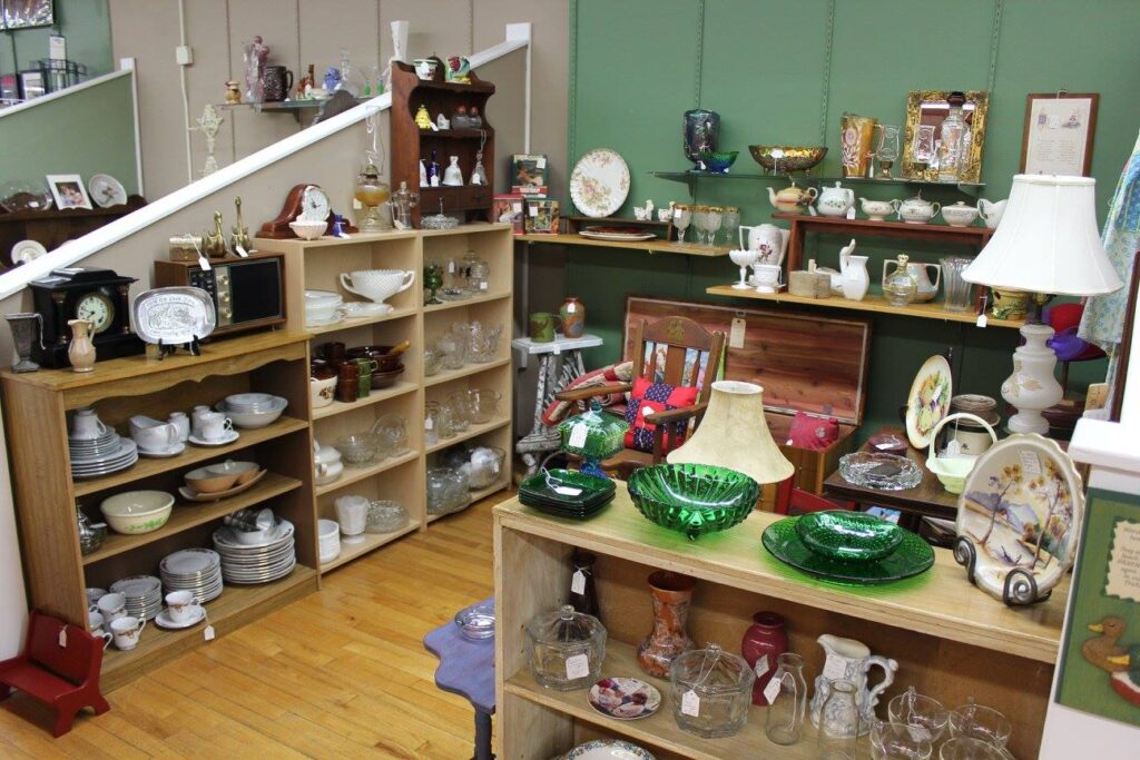 Interior of Galax antique stores booth with glassware, dishes, and vintage household items